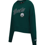 A dark green cropped crewneck sweatshirt featuring 'Bucks' in white script with a black outline and the Milwaukee Bucks logo on the front, shown on a plain white background.