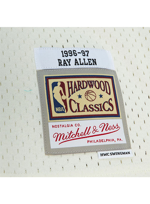Mitchell & Ness HWC '93 Energy Ray Allen Milwaukee Bucks Swingman Jersey in Cream, Purple, and Green - Zoom View Left Hip Tag