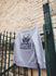 Homage HWC '93 Grey Hand Drawn Milwaukee Bucks Crewneck Sweatshirt In Grey - Front View Lifestyle Photo Hanging On Gate