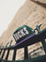New Era 59Fifty HWC '93 Wordmark Milwaukee Bucks Fitted Hat In Green & Purple - Front Left View Lifestyle Photo On Gate