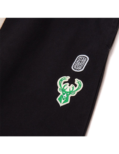Standard Issue Slacker Wordmark Milwaukee Bucks Pants In Black - Left Thigh Logo View