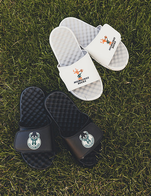 iSlide Hardwood Classics '68 Mantra Milwaukee Bucks Sandals In Black - Lifestyle Shot Of Sandals On Ground